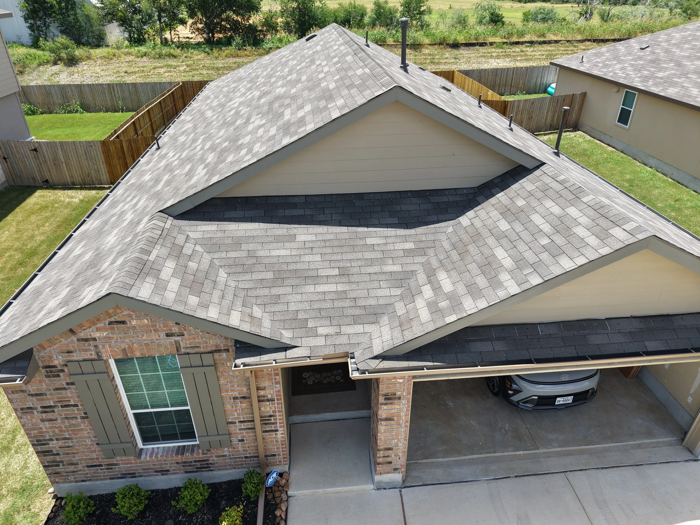 Aerial view of a completed Revamped Roofing residential roof