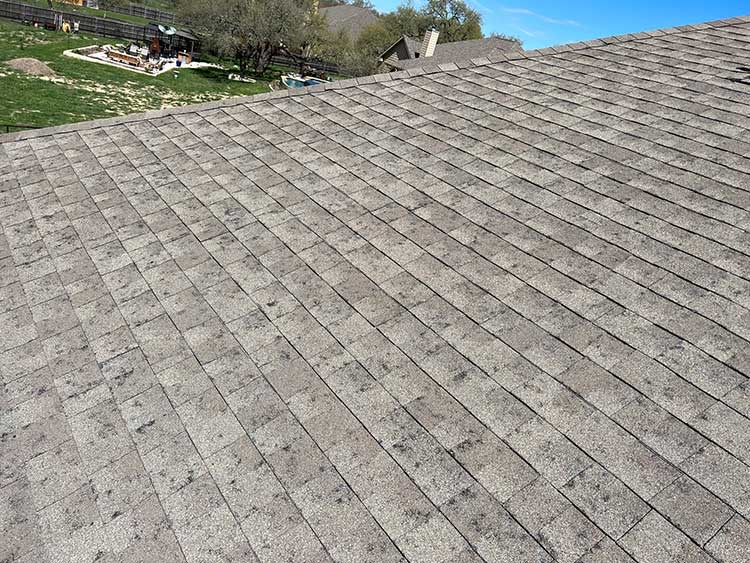 Hail-damaged shingles documented by Revamped Roofing