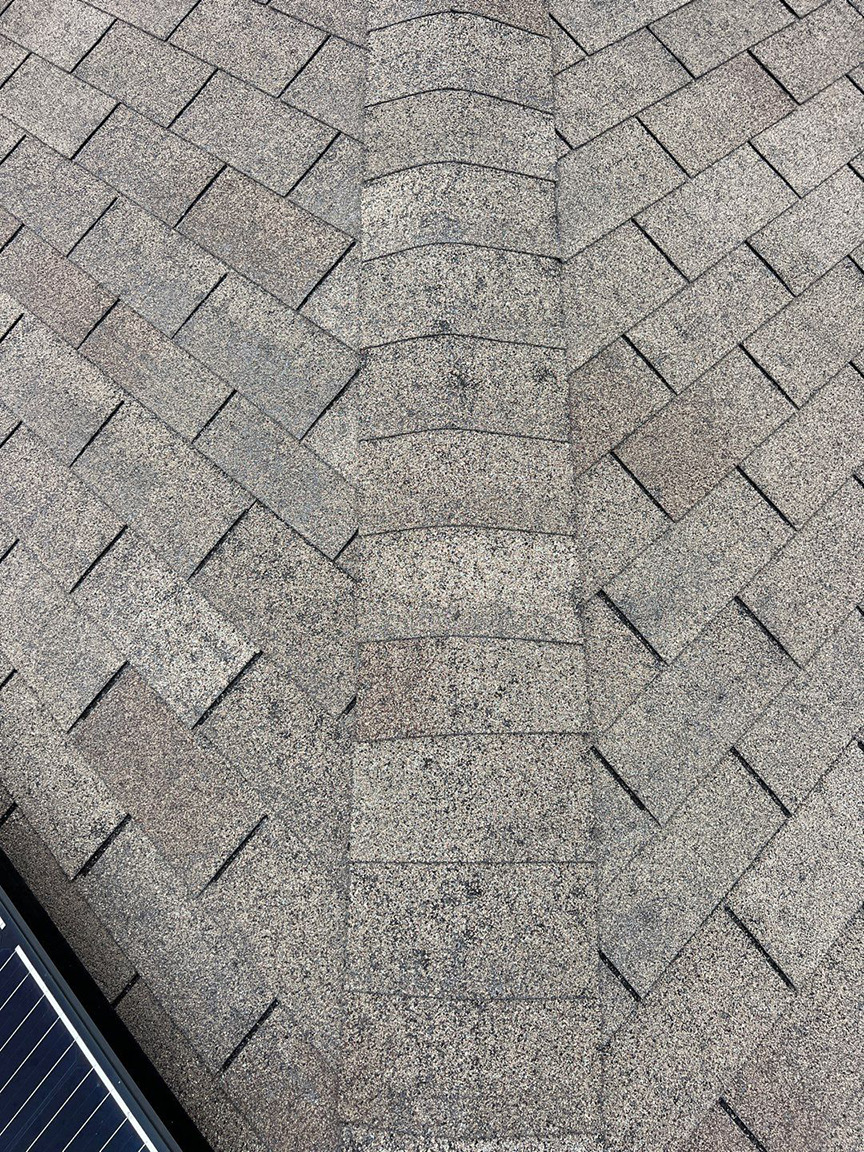 Storm wear visible where roof planes meet